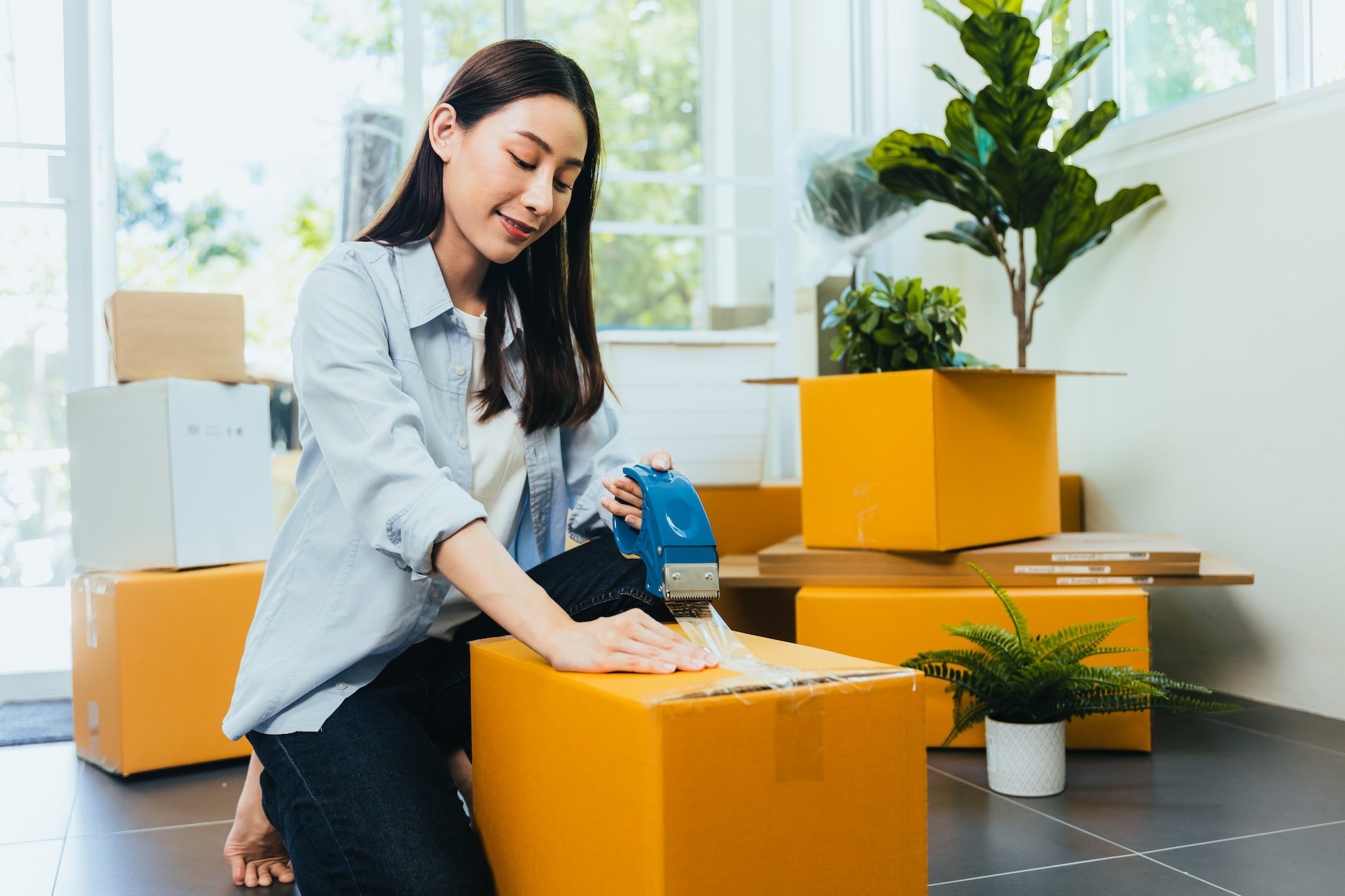 Asian woman moving into a new home.