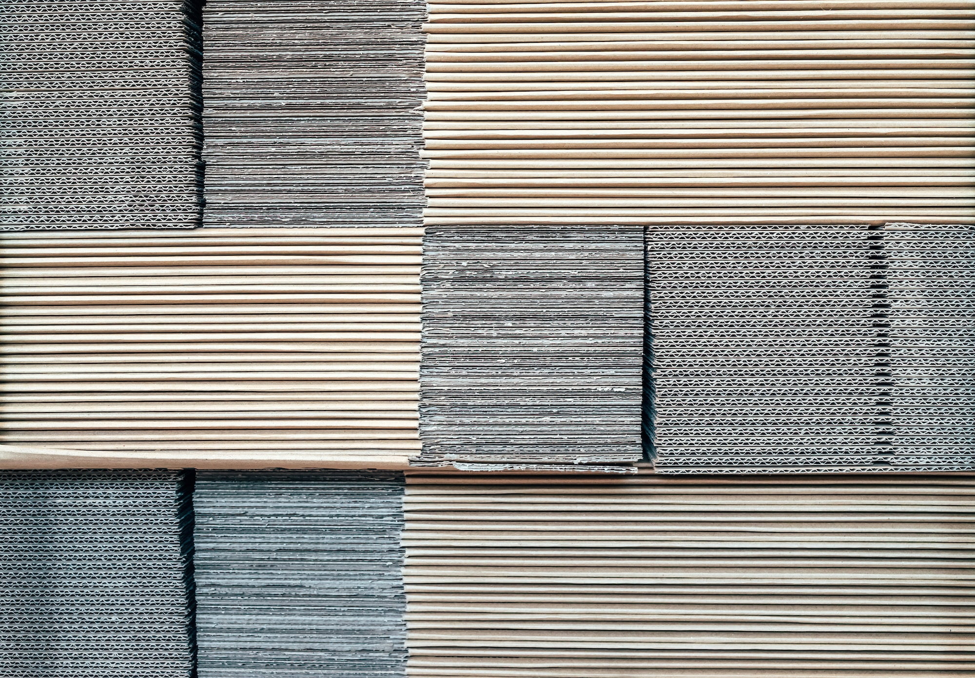 A stack of white and grey tiles on a wall.