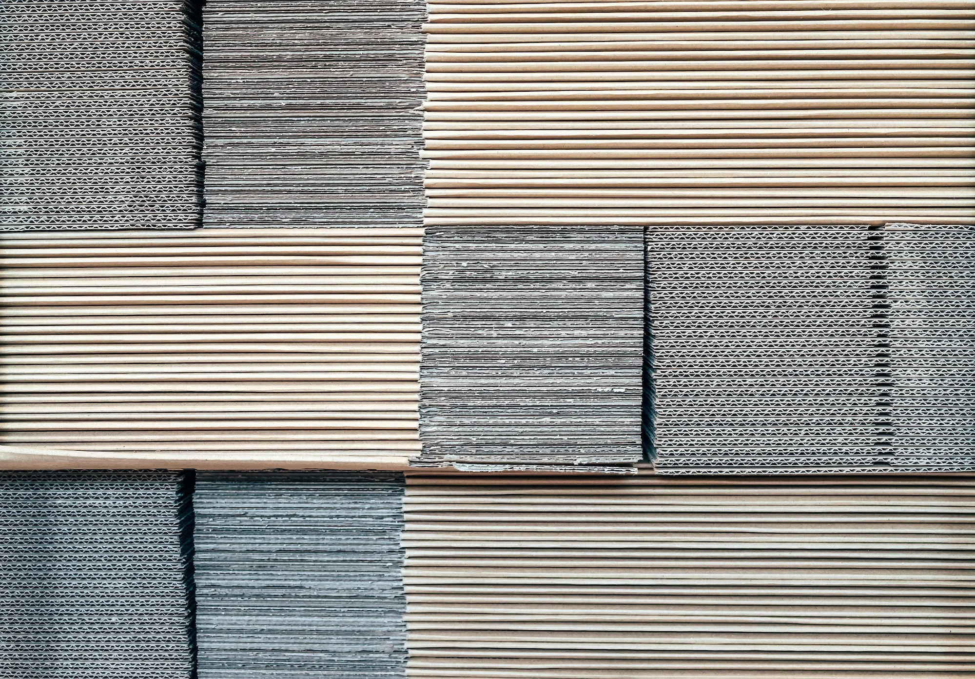 A stack of white and grey tiles on a wall.