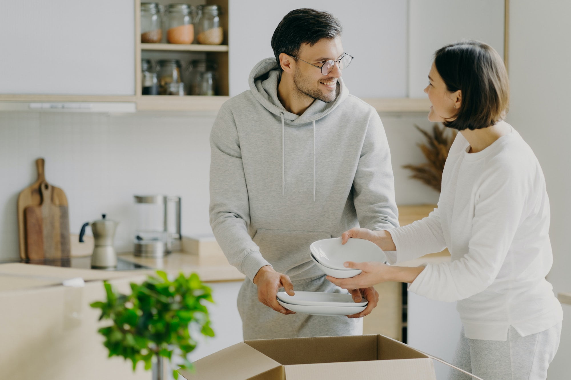 A man and woman are moving into a new home.