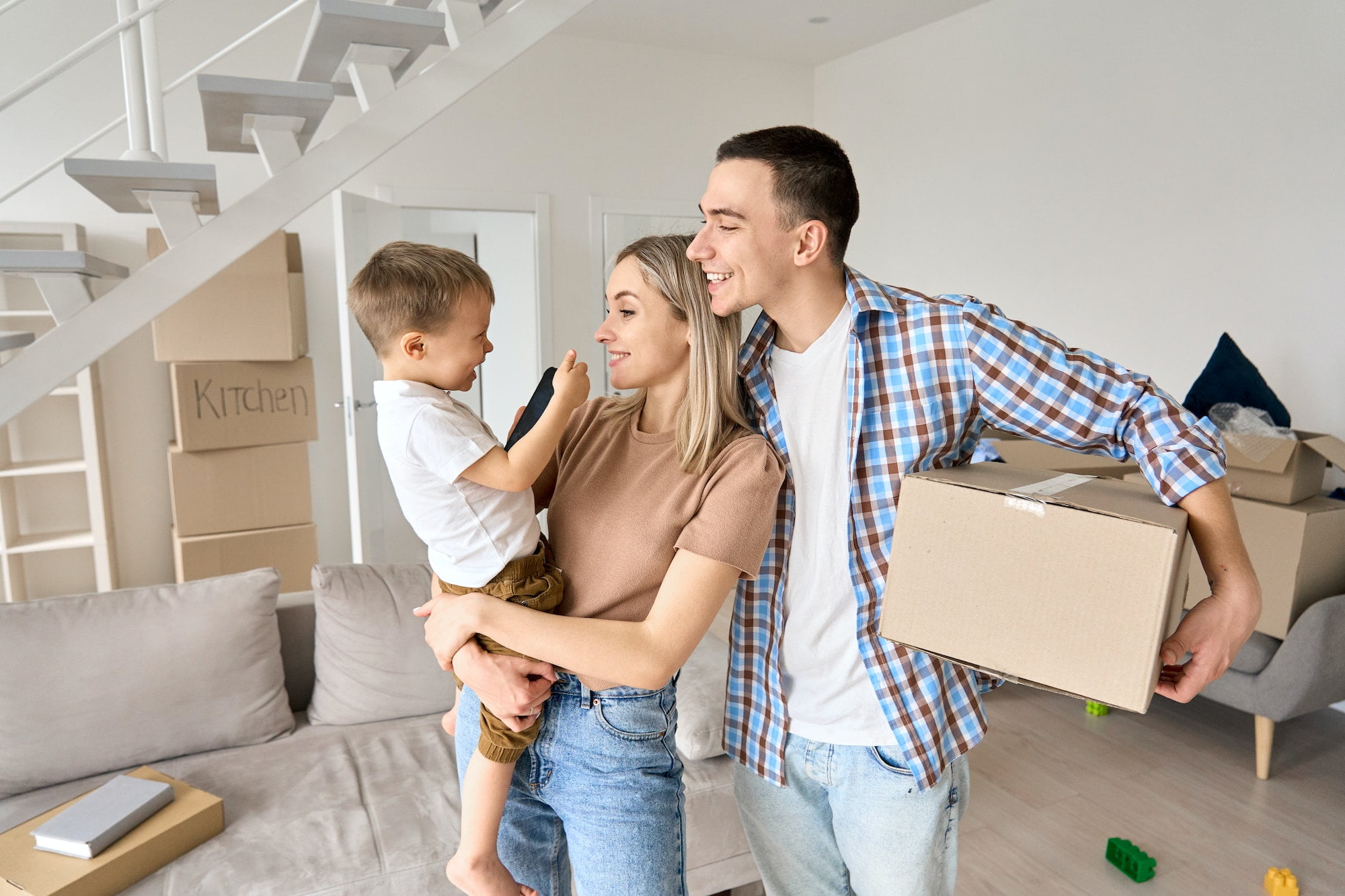 Happy family moving into a new home stock photo.