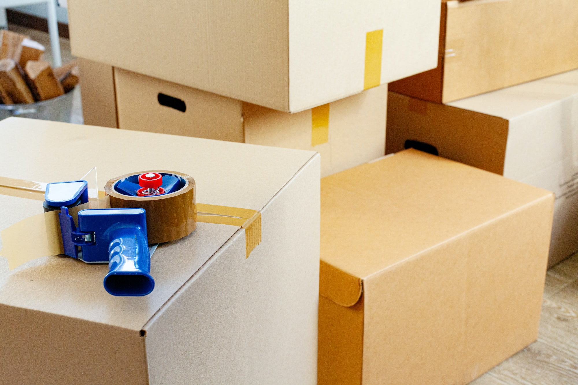 Moving boxes in a room with a tape dispenser.