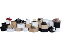 A chic arrangement of various hats is artfully displayed on an array of stacked boxes in classic black, white, and brown tones.
